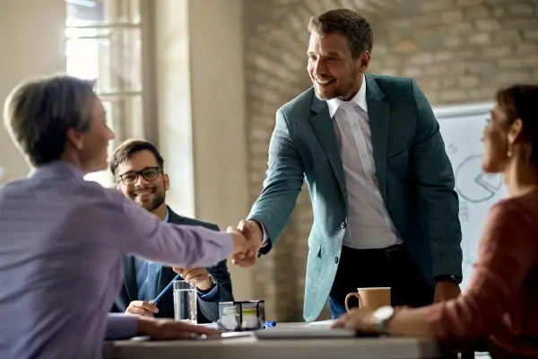 business-coworkers-shaking-hands-during-meeting-office-focus-is-businessman (1)